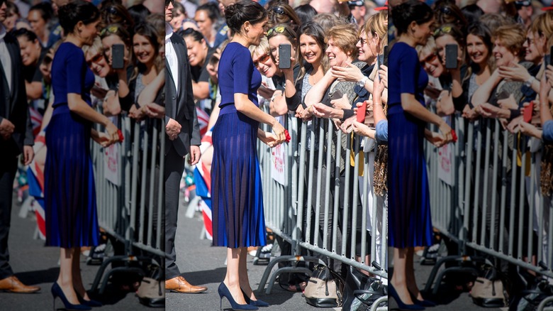 Meghan Markle in blue dress greeting fans in New Zealand