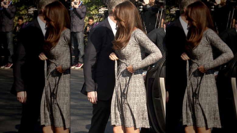 Catherine Middleton tying belt on wrap dress