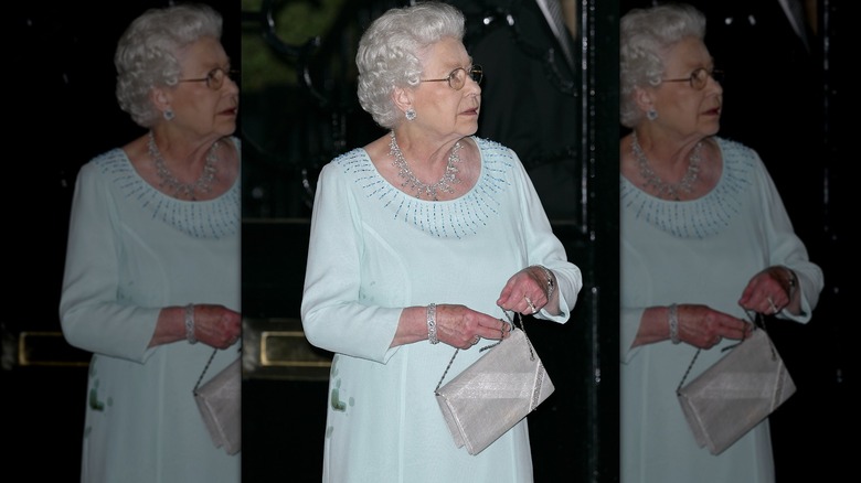 Queen Elizabeth in stained green dress with broken purse strap