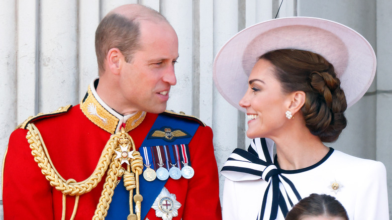 Catherine, Princess of Wales smiling at William, Prince of Wales on the balcony during Trooping the Colour 2024