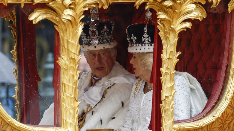 King Charles III speaking to Queen Camilla in the Diamond Jubilee State Coach during his coronation