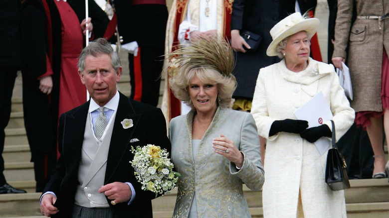 Queen Elizabeth II walking behind King Charles III and Queen Camilla outside Guildhall on the couple's wedding day