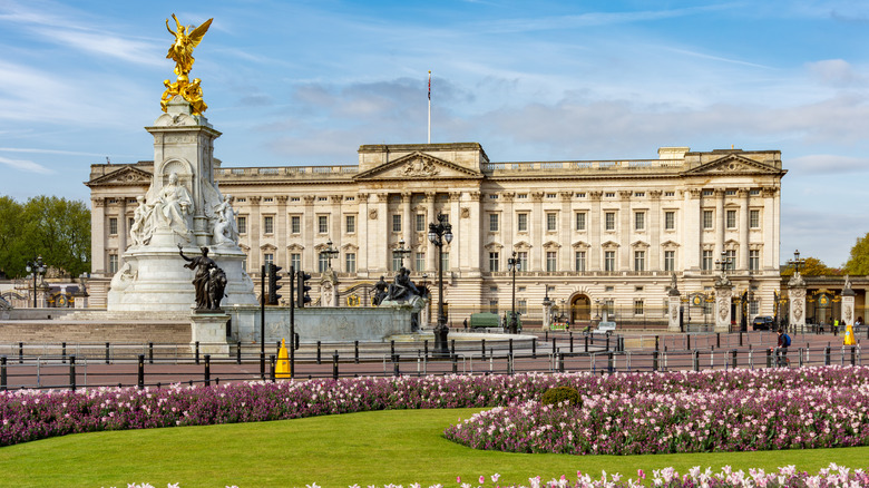 Buckingham Palace with Victoria monument and flowers in front