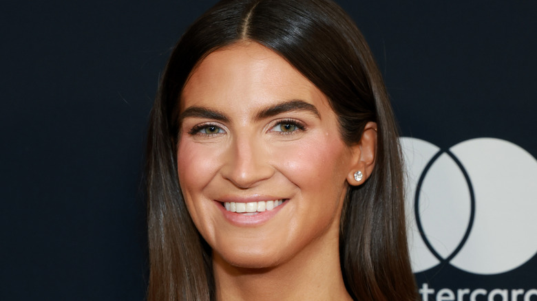 Kaitlan Collins smiling while posing at an event