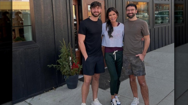 Kristi Noem poses with Drew and Zeke of River City Relics in Yankton, SD (2024)