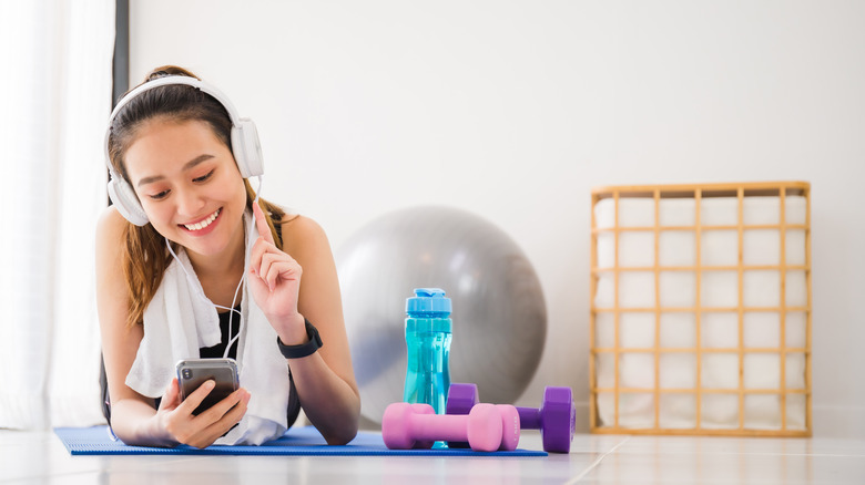 Woman chooses music to listen to while working out