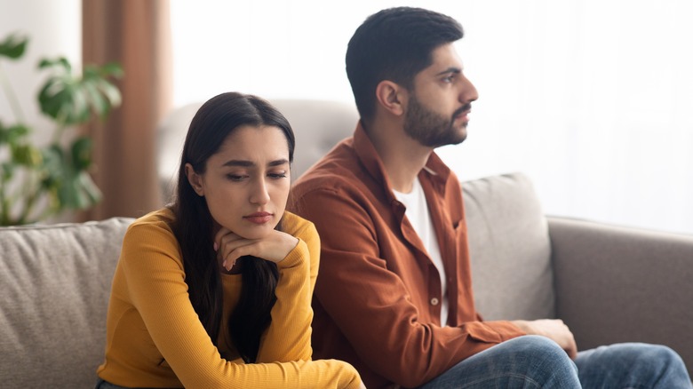 Woman and man turned away from each other