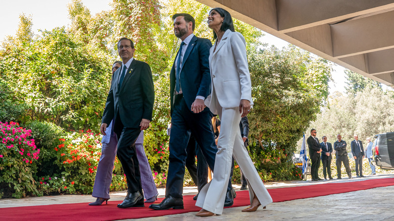 JD Vance and Usha Vance smiling and walking