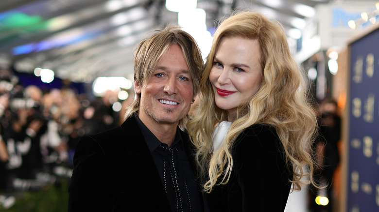 Keith Urban and Nicole Kidman smile for the camera at an event