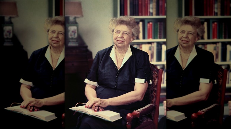 Eleanor Roosevelt sitting with a book in her lap
