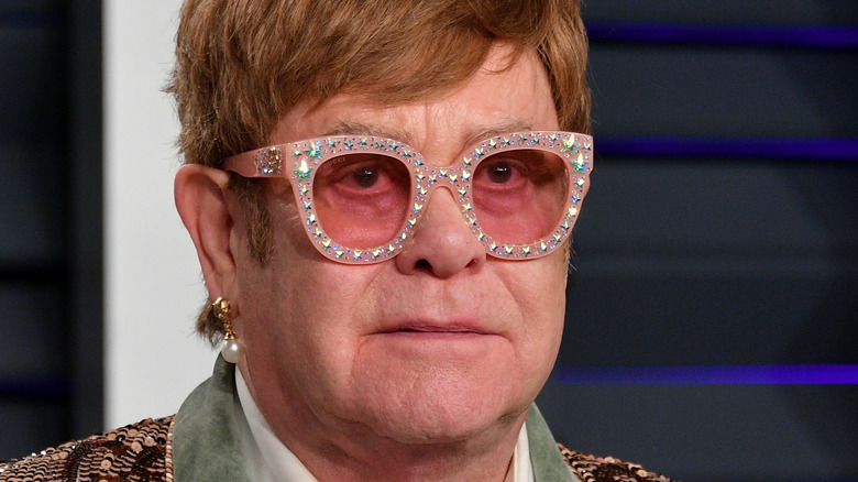 Elton John poses on the red carpet