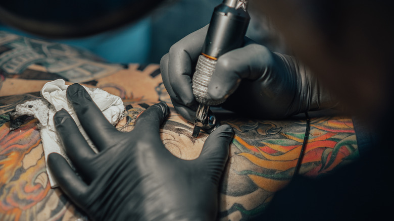 tattoo artist giving tattoo