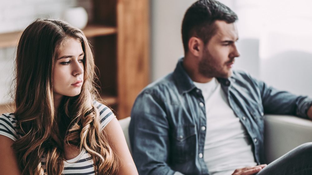 Unhappy couple sitting on a sofa