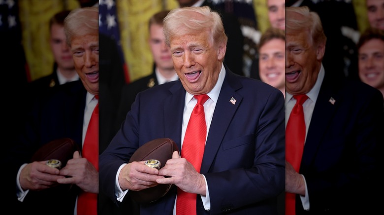 Donald Trump sticking out his tongue while holding a football