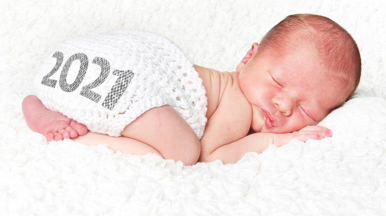 baby sleeping on blanket