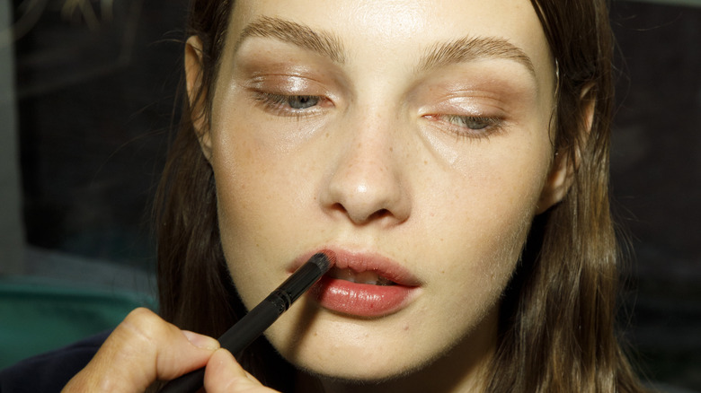 Woman applying lip product