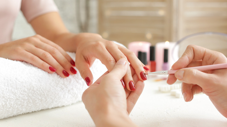 Close up of person getting their nails done 