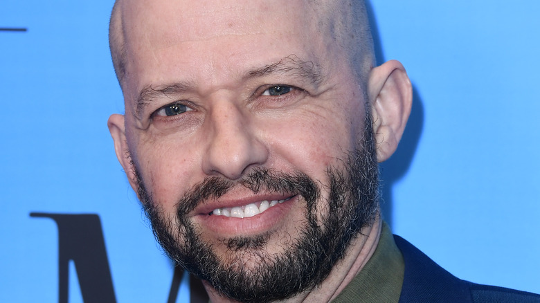 Jon Cryer smiles on the red carpet