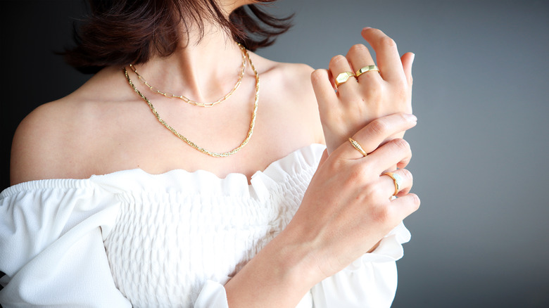 Woman wearing necklace and rings