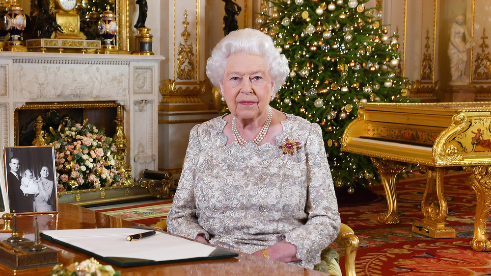 Queen Elizabeth sitting at desk