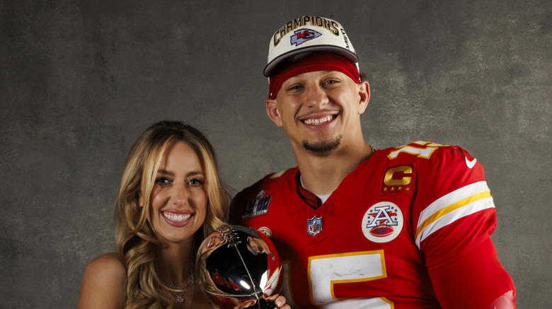 Patrick and Brittany Mahomes hold a trophy