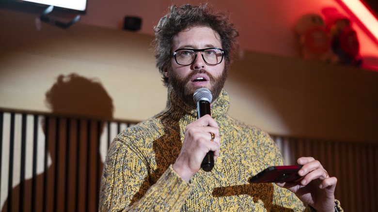 T.J. Miller mid-sentence during a stand-up comedy presentation.