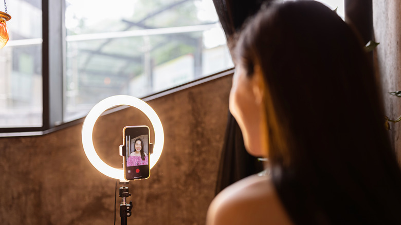 Woman using ring light for selfie