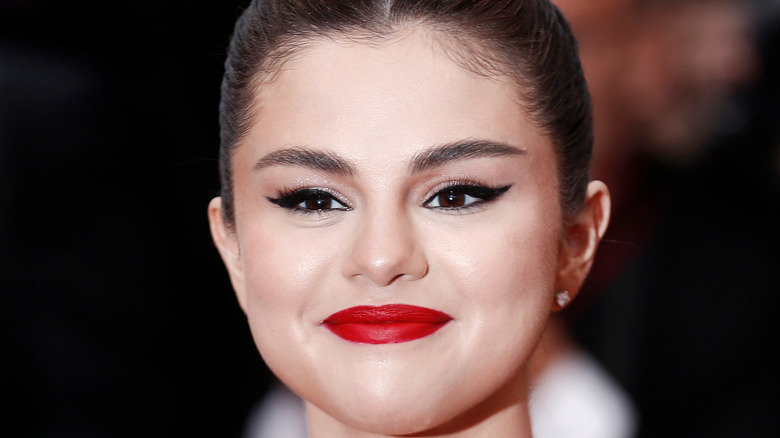 Selena gomez smiling with cateye 