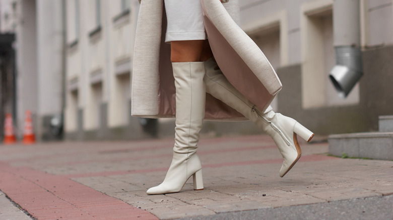 woman wearing tall white boots