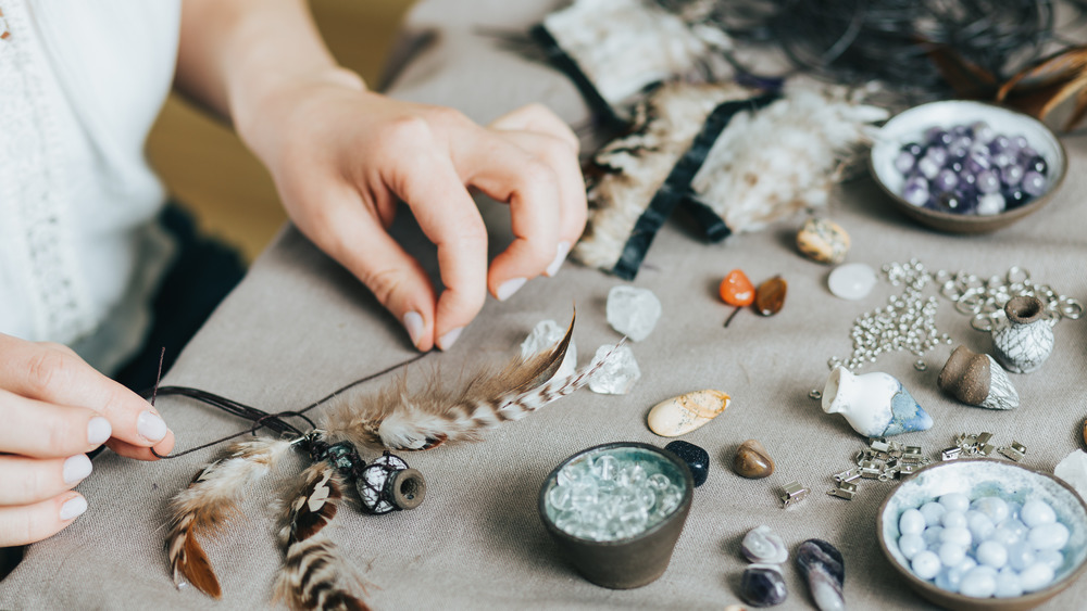 Woman making jewelry with crystals
