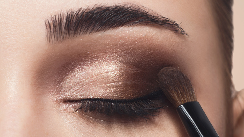Woman applying eyeshadow