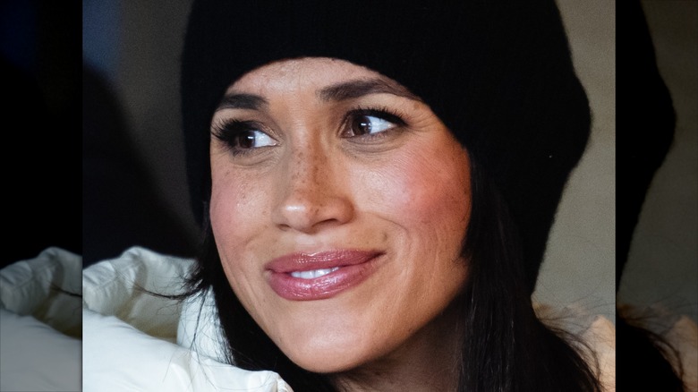 Close on Meghan Markle in a black beanie.