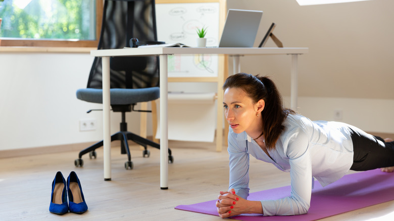 Woman exercising in home office