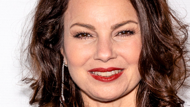 Fran Drescher smiling with red lip