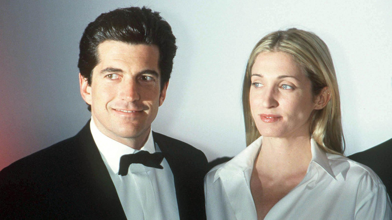 John F. Kennedy Jr. and Carolyn Bessette smiling at event