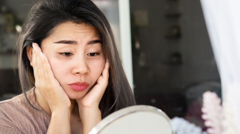 Woman looking in mirror