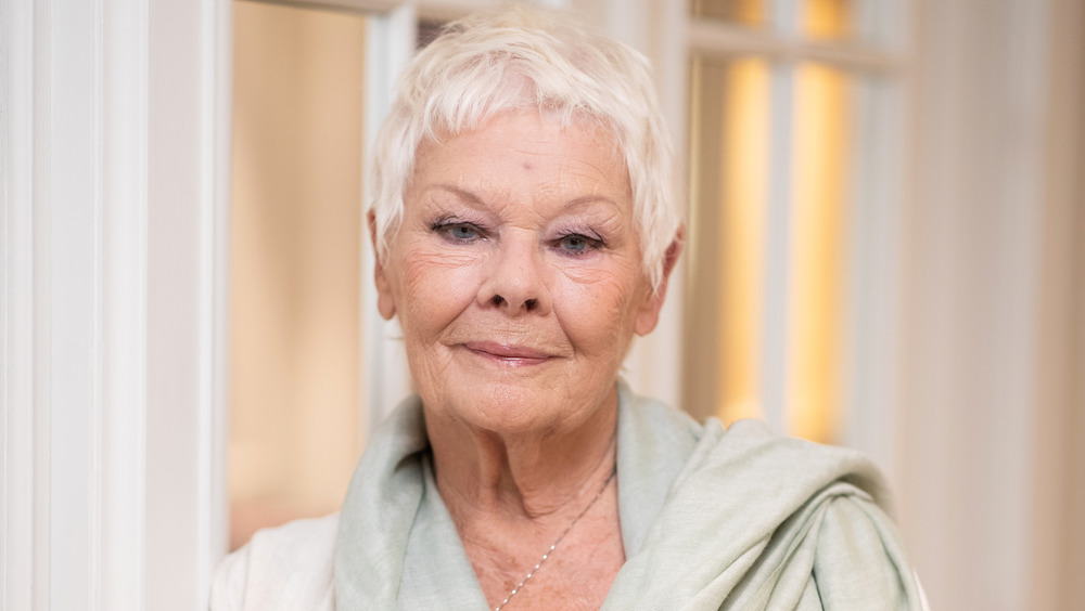 Judi Dench posing in beige shawl