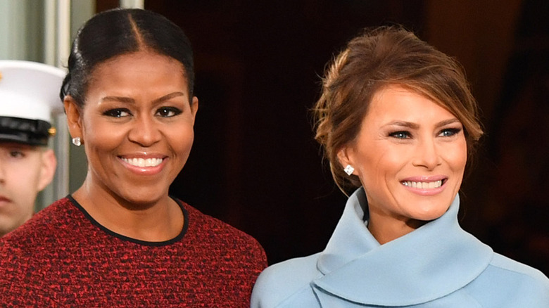 Michelle and Melania standing and smiling