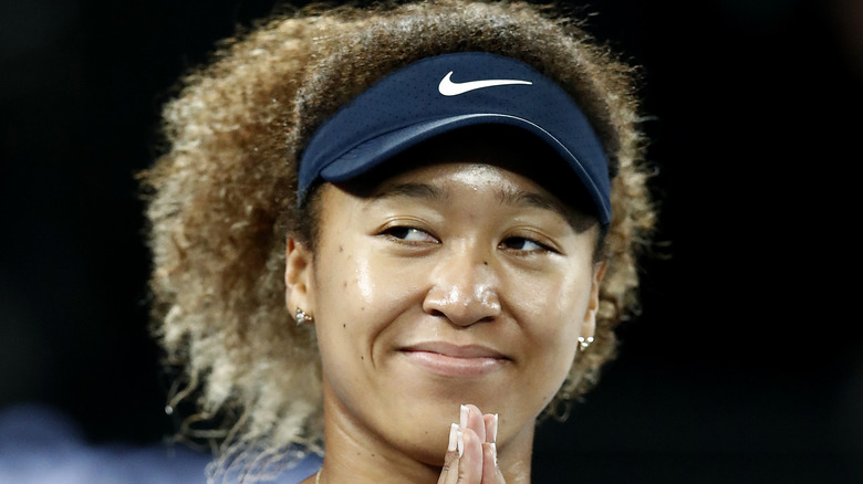 Naomi Osaka doing prayer hands 