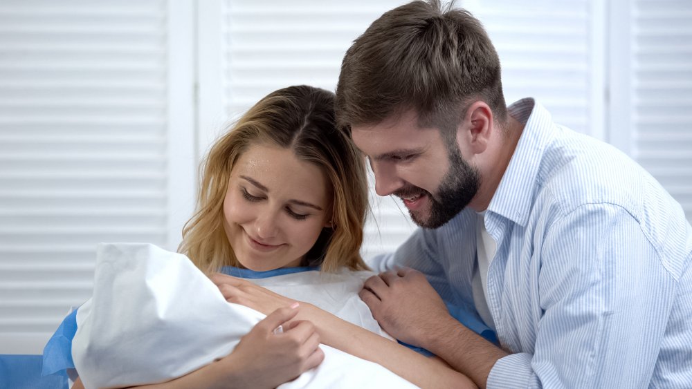 happy couple with new baby