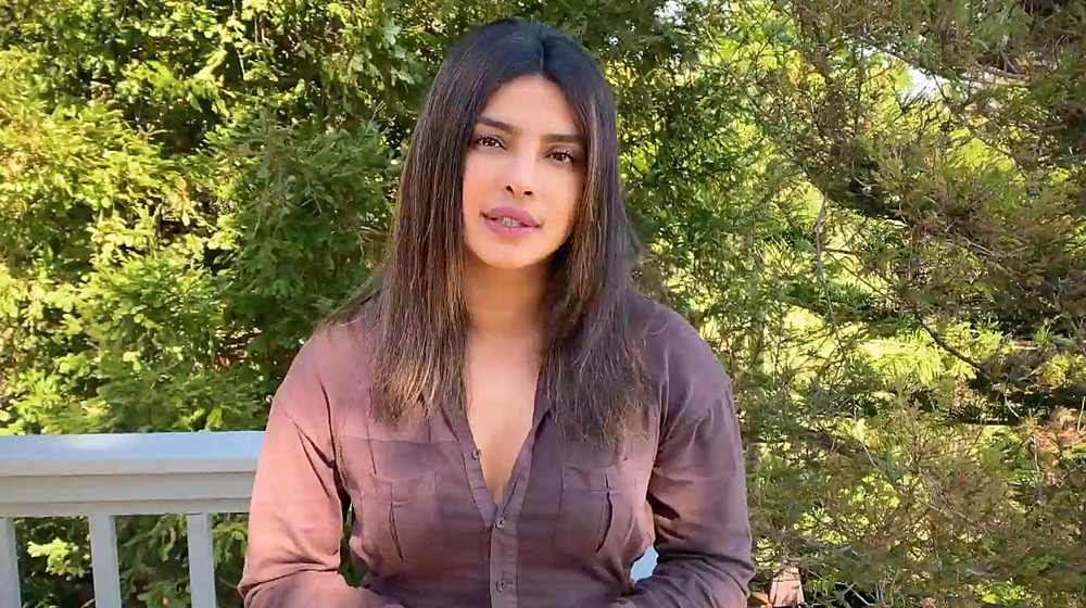 Priyanka Chopra sits outside