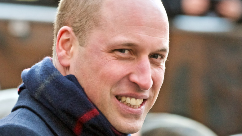 Prince William smiling in a scarf