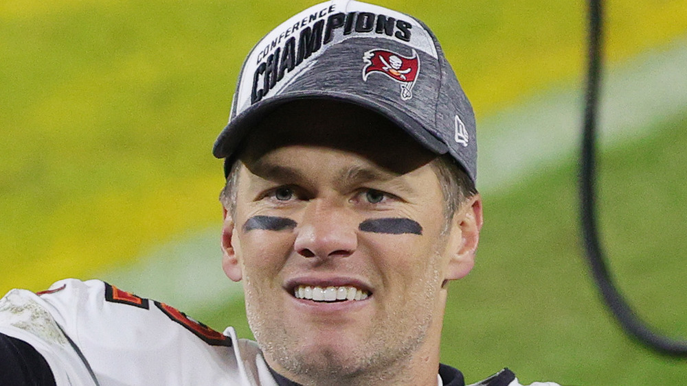 Tom Brady smiling on field