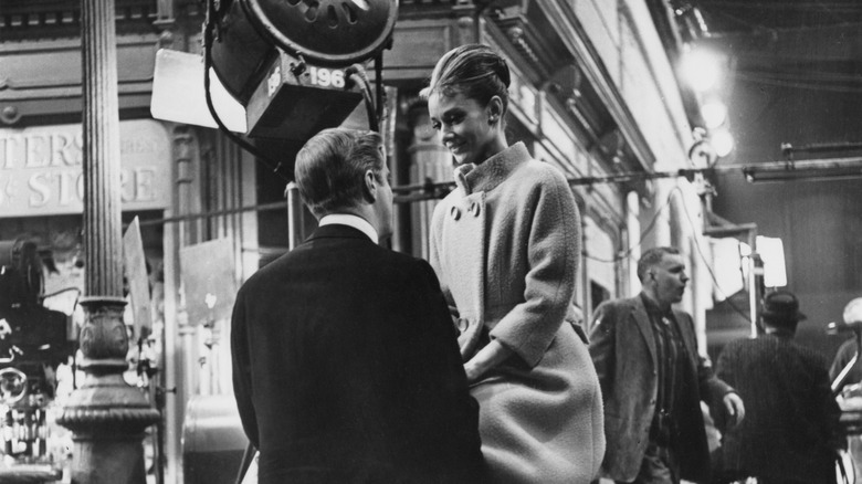 Audrey Hepburn, right, looking down and smiling at George Peppard