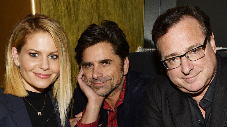 Candace Cameron Bure, John Stamos, and Bob Saget smiling