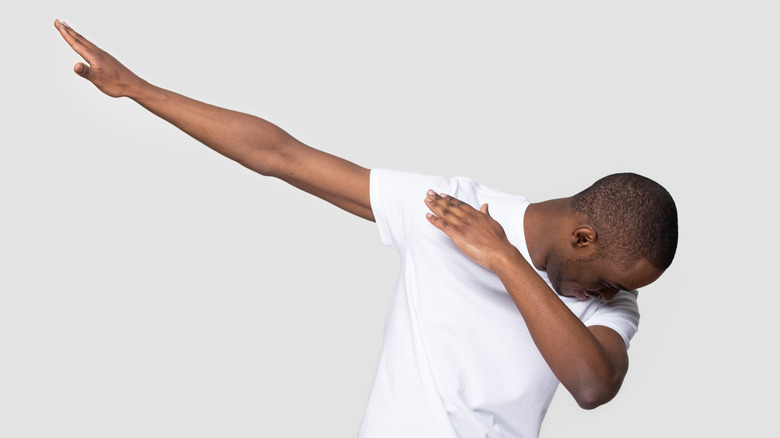 man dabbing against white background