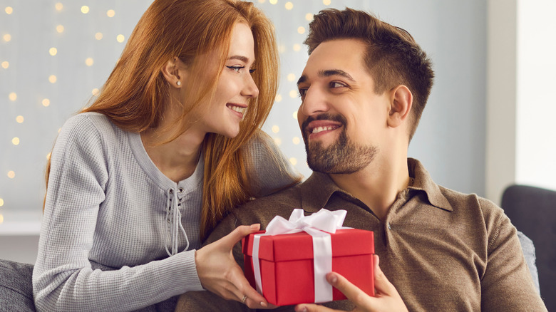 Romantic couple giving gifts 