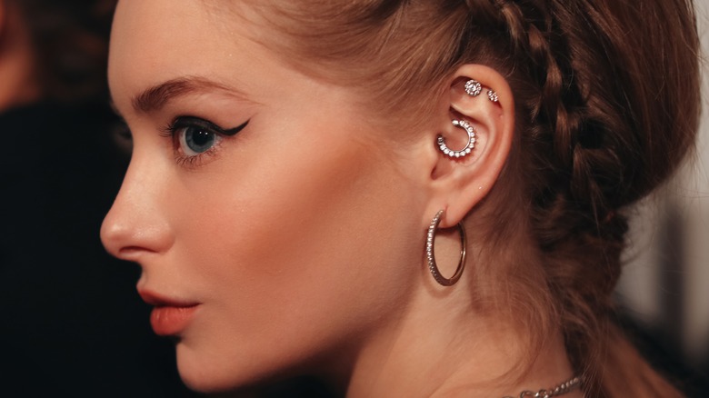 woman with various ear piercings
