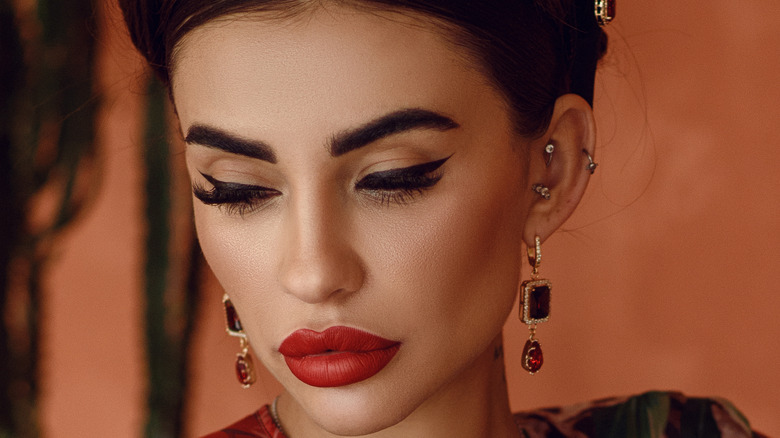 Woman with makeup and ear piercings