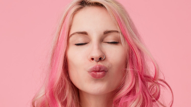 Woman with pink hair and piercings 